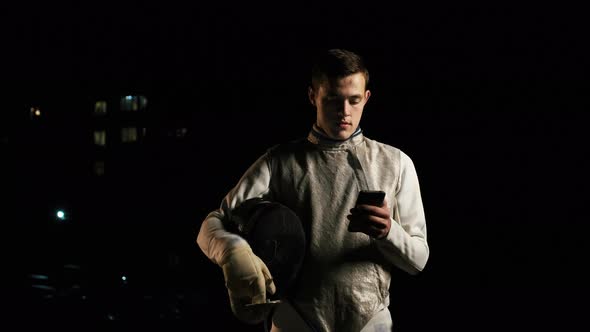 Portrait Of Young Fencer Man Looking Into Camera On The Street.