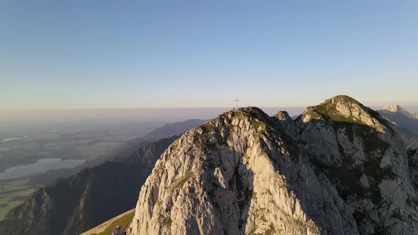 Aerial view of hiker on mountain peak during sunset