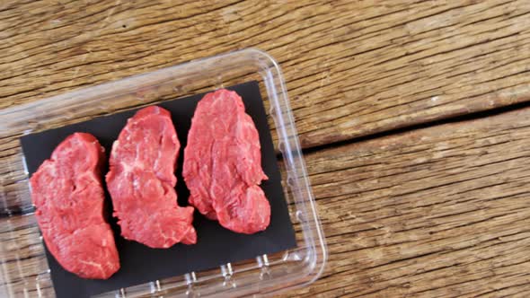 Beef steak in plastic container