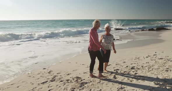 Senior couple walking together at the beach