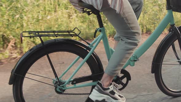 Unrecognizable Woman Riding Bike In Summer