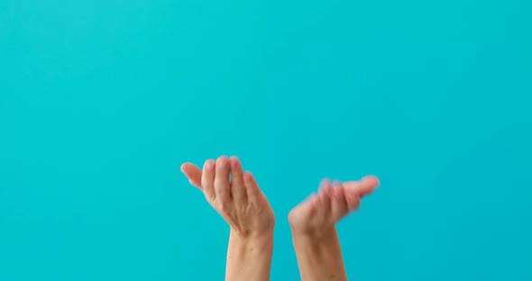 Woman Does Begging Gesture By Palms on Turquoise Background