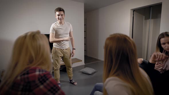 Happy Smiling Teens Playing Charades in Living Room