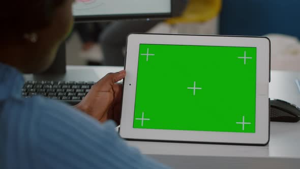 Close Up of African Worker Immobilized in Wheelchair Looking at Tablet with Mock Up Display