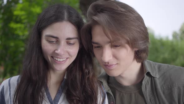 Portrait of Cute Young Couple Tenderly Rubbing Their Noses and Kissing Close Up. Happy Girl and Boy