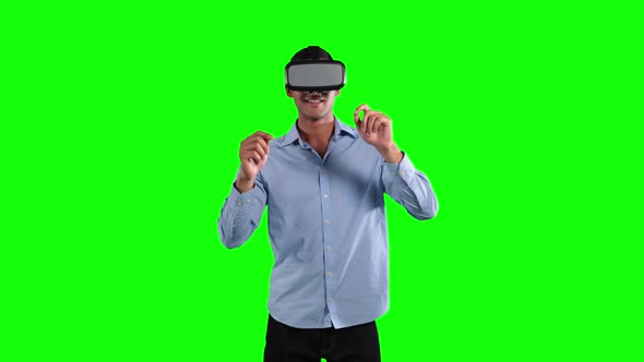 a Caucasian man wearing 3D goggles in a green background