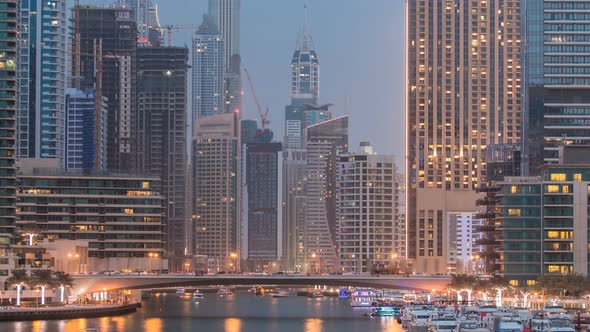 Evening Dubai Marina City Centre with Floating Vessels Day to Night Timelapse