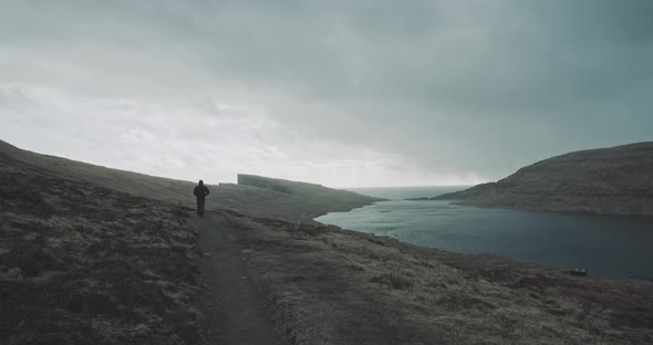 Person walks along river