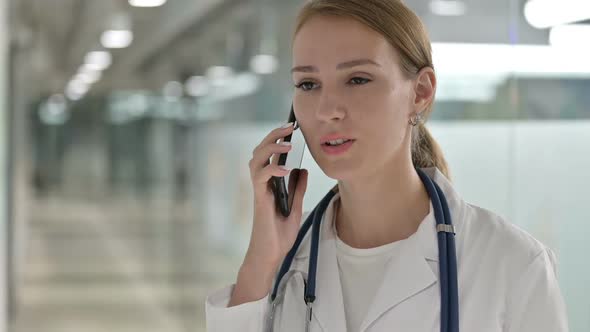 Female Doctor Doing Talking on Smartphone