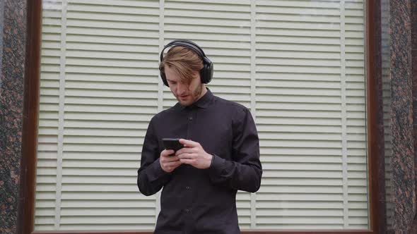 The Guy Listens to Music in Headphones