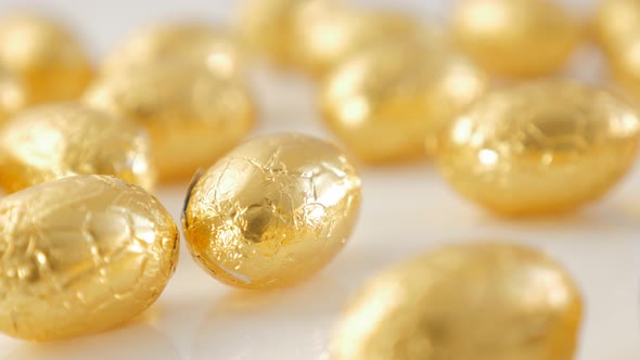 Easter  golden chocolate eggs on reflective white background 4K 3840X2160 UHD footage - Chocolate Ea