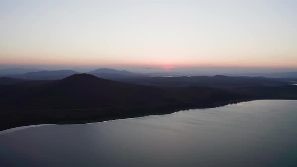 Aerial Footage of a Flock of Whitenecked Cranes at Sunset