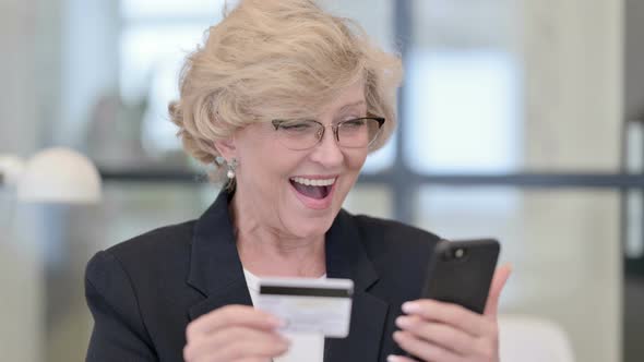 Portrait of Old Businesswoman with Successful Online Shopping on Smartphone