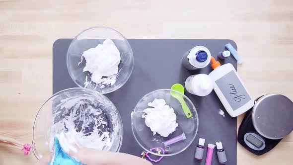 Time lapse. Step by step. Flat lay. Mother and daughter making colorful fluffy slime.