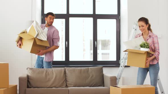 Happy Couple with Stuff Moving To New Home