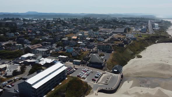 Counterclockwise drone shot of the town of Newport, Oregon from Nye Beach on a relaxed summer day. T