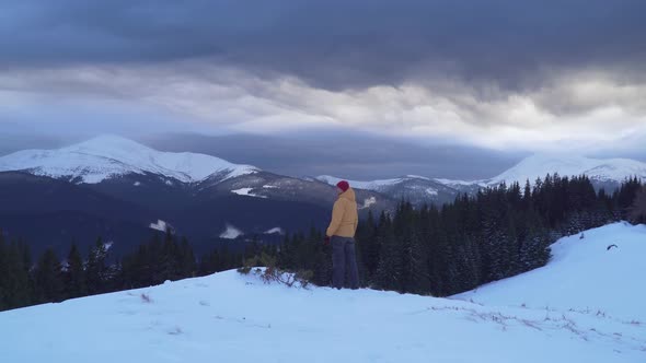 A Man Travels in the Mountains in Winter