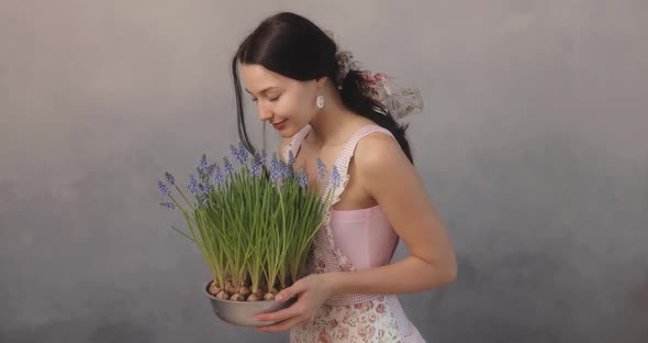 Woman Holding Bouquet of Flowers in Hands Indoors