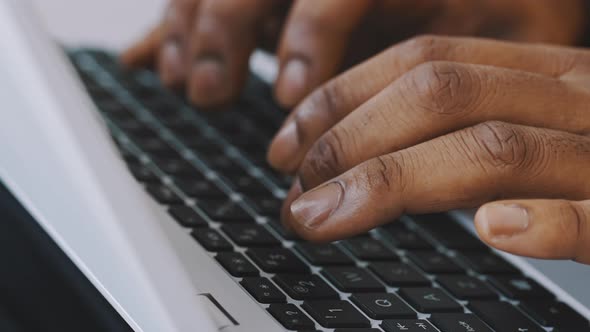 Close Up Shot of Hands of Unrecognizable Afroamerican Businessman Typing on Laptop Keyboard