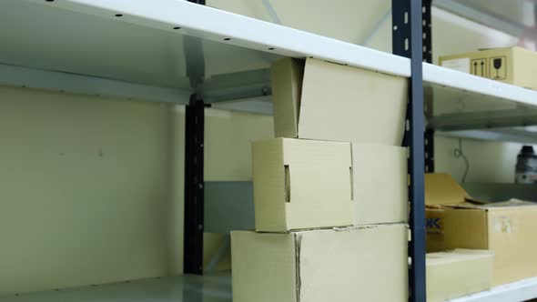 Logistics warehouse, time lapse. Shelves are filled with boxes with cargo and goods in the warehouse alt