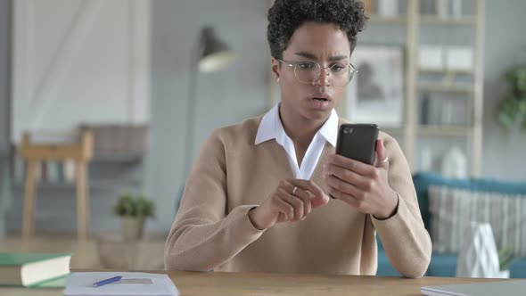 Young African Girl Using Phone And Getting Stressed