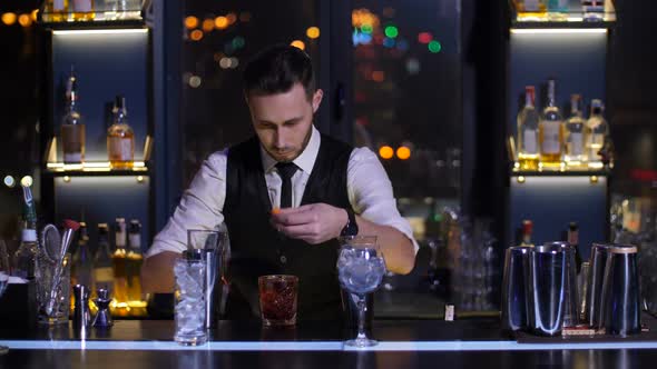 Bartender Burning Orange Peel for Cocktail