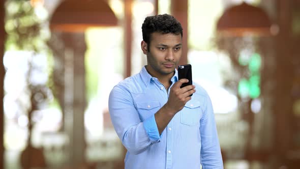 Brownskinned Office Worker Taking Photos of Someone Unnoticeably