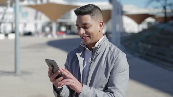 Smiling Handsome Brunet Having Video Call Through Smartphone