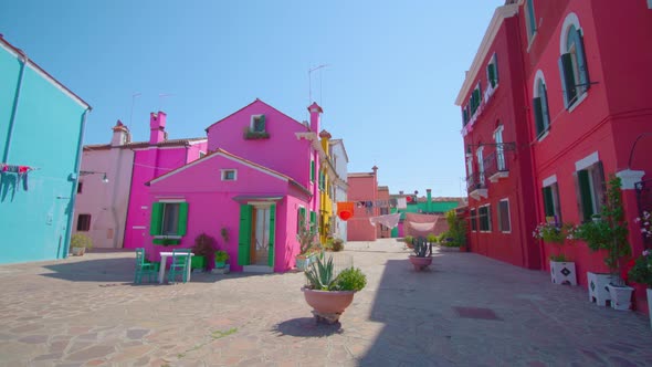 Colorful Houses with Shutters and Flowerpots with Plants