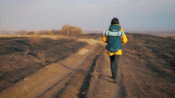 Woman Traveler with Backpack Walking in the Mountains, Freedom and Happiness. Active Sport Lifestyle