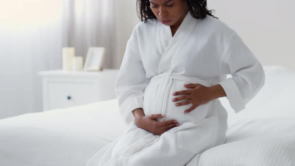 Worried Pregnant Black Woman Touching Belly Feeling Labor Contractions Suffering From Braxton Hicks