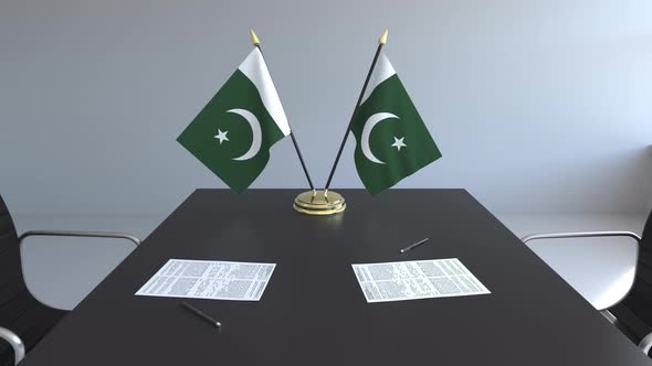 Flags of Pakistan and Papers on the Table