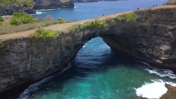 1 million $ drone aerial view flight over natural bridgeBroken Beach at Nusa Penida in Bali Indones