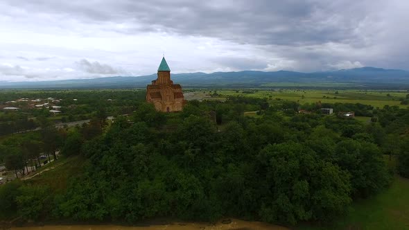 Drone Flying Over Old Georgian Gremi Church Standing on Green Hill, Architecture