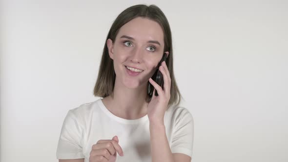 Young Woman Talking on Smartphone on White Background