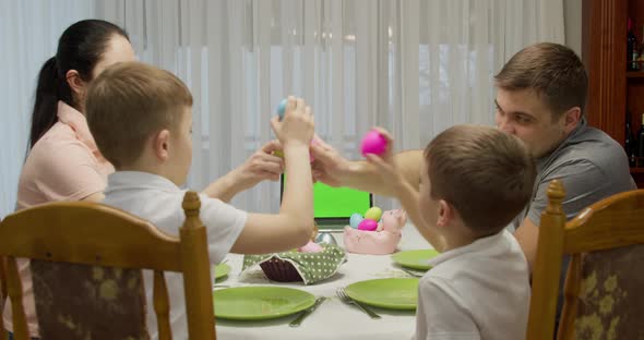 Family of Four Talking and Having Dinner Sitting at the Table