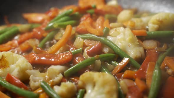 Close Up Chef Cooking Vegetables in Pan