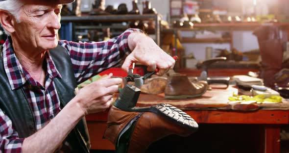 Shoemaker repairing a shoe