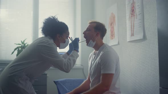 Nurse Taking Saliva Sample From Patient