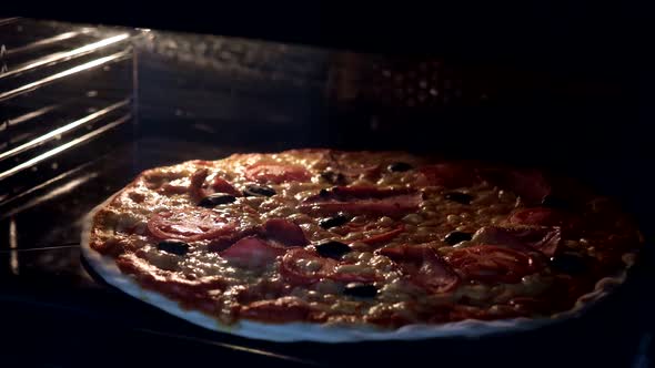 View from inside of the oven. Cooking italian pizza in electric convection oven. Closeup of pizza 