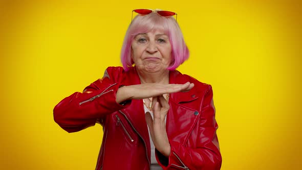 Senior Old Stylish Rocker Granny Woman with Pink Hair Showing Time Out Gesture Limit or Stop Sign