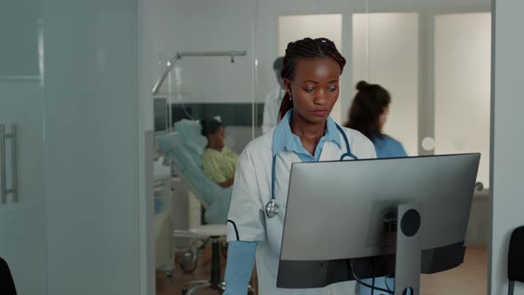 Woman Working As Doctor with Stethoscope Using Computer