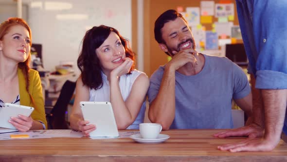 Business colleagues interacting with each other in meeting