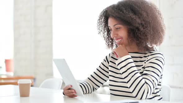 African Woman Doing Video Chat on Tablet 