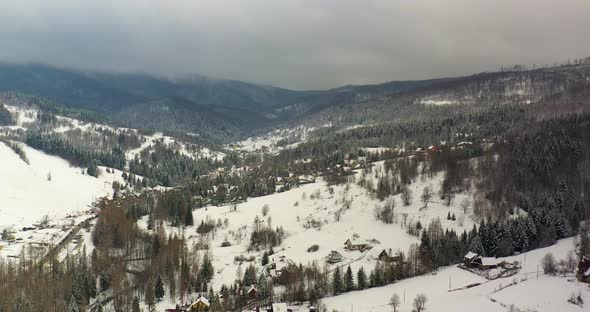 Forest Covered with Snow Aerial View. Aerial View of Village in Mountains