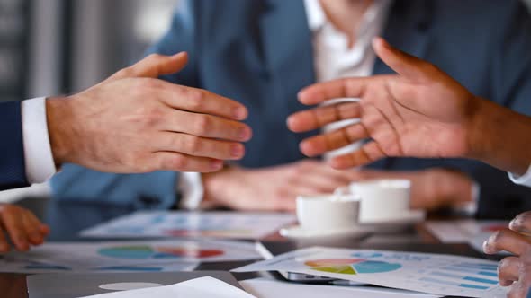 Business handshake: two colleagues shaking hands at a business meeting in the office