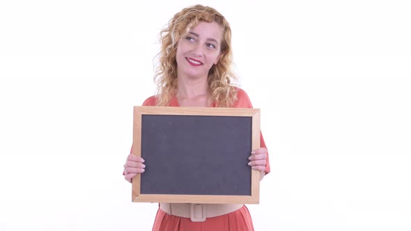 Happy Beautiful Blonde Businesswoman Thinking While Holding Blackboard