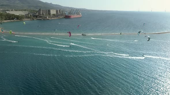 Aerial view of beach in the Gulf of Patras with group doing windsurfing. Greece.