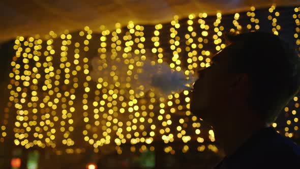 A Young Man Spends Time in a Hookah Bar