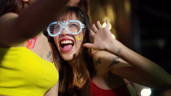 4K Group of Asian woman using mobile phone taking selfie together at full moon beach party